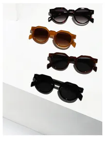 Detail of retro thick-frame sunglasses in various colors with metallic dot accents