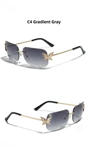Detail view of C4 gradient grey rimless sunglasses with butterfly rhinestone accents