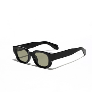 Classic black cat-eye sunglasses with wide temples and subtle green lenses