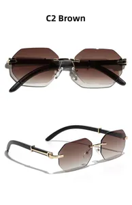Detail of rimless polygon tea sunglasses with gold C-hinge and black temple arms