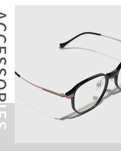 Detail of square glasses with black TR90 frame, gold titanium temples, and lens specifications