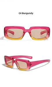 Detail view of rectangular pink to orange gradient sunglasses with light brown lenses