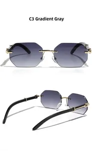 Detail of rimless octagonal sunglasses with gradient grey lenses and gold metal accents