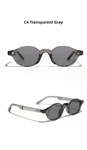 Detail of transparent gray oval sunglasses with silver diamond hinge accents and gray lenses