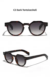 Detail view of dark tortoiseshell retro round sunglasses with gradient lenses