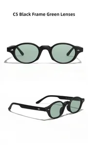 Detail shot of black matte frame sunglasses with green lenses and silver diamond rivets