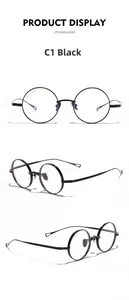 Macro detail of black titanium round frame spectacles showing model number and size specs