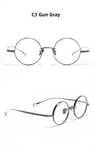 Detail of gunmetal gray titanium round frame glasses with IP 99.99% titanium marking