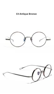Close-up of vintage round titanium glasses frames in bronze color with IP plating detail