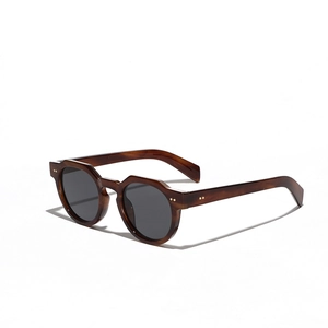 Retro round thick frame tortoiseshell sunglasses with dark lenses and metal rivets