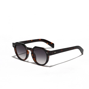 Retro tortoise shell round sunglasses with metallic rivets and dark grey gradient lenses