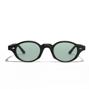 Retro oval sunglasses with black matte frames and light green lenses for a classic look