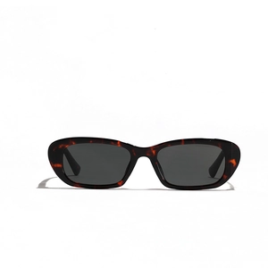 Retro oval tortoise shell sunglasses with dark lenses for a minimalist vintage look