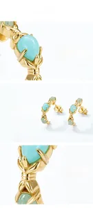 Macro detail of 18K gold C-shape silver earrings featuring three oval amazonite stones