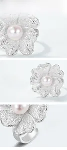 Detail of S925 silver orchid ring with lace texture and centered white pearl