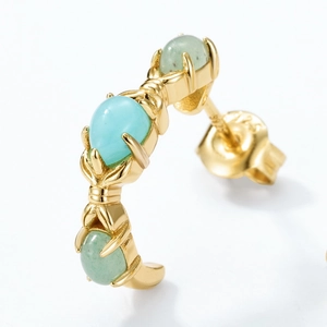 Detail of C-shape S925 silver earring with triple oval gemstones and gold plating