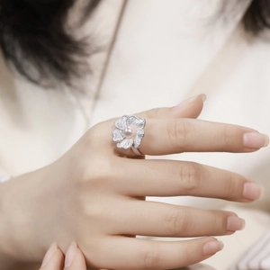 Handcrafted brushed silver orchid flower ring featuring a soft pink pearl center