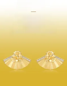 Macro detail of hand-brushed gold fan-shaped earrings with floral zircon inlay