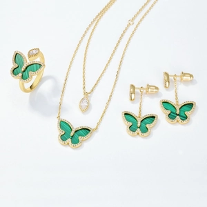 Elegant gold butterfly jewelry set featuring malachite stones and sparkling white zircons