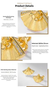Macro detail of handmade brushed gold fan earrings with high-clarity white zircon stones
