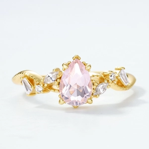 Luxurious S925 gilded pink crystal ring with pear-cut stone and twisted band design