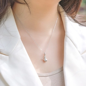 Cute brushed S925 sterling silver snowman pendant necklace worn by a fashion model