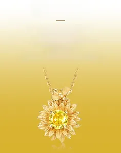 Detailed macro view of S925 silver sunflower pendant with brushed gold finish and a bee