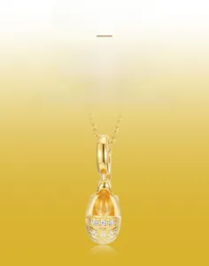 Macro detail of handmade brushed gold stroller pendant with sparkling crystal inlay