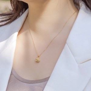 Elegant gold-plated S925 silver baby stroller pendant necklace on female model