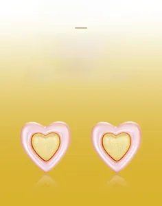 Detail of S925 silver heart stud earrings with handcrafted brushed texture and pink shell