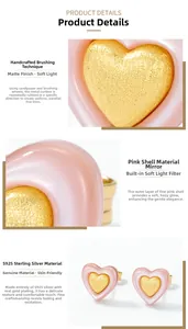 Detailed macro of S925 silver heart stud earrings with pink shell and brushed gold