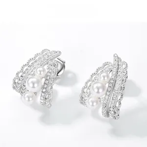 Detail of silver lace earrings with three pearls and sparkling zircon accents