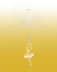 Detail of gold ballet dancer pendant showing fine brushed texture and inlaid zircons