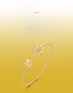 Detailed view of handmade brushed golden flower bracelet with sparkling zircon stones