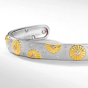 Brushed S925 silver cuff bracelet with golden daisy patterns and sparkling stones