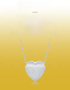 Detail of 925 sterling silver heart pendant featuring a fine handcrafted brushed metal texture