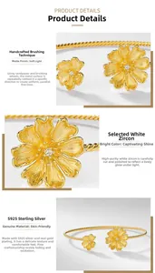 Detail of handmade brushed gold flower bangle with sparkling white zircon stone