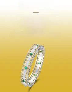 Detail of hand-brushed S925 silver cuff bracelet featuring square green emerald gemstones