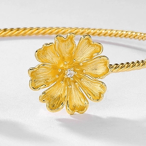 Minimalist gold flower open bangle with hand-brushed petals and rope-textured band for women