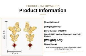 Detail of S925 sterling silver butterfly earrings with brushed gold and red garnet