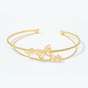 Double-layered gold butterfly bangle with twisted rope texture and cubic zirconia accents