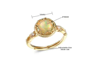 Detail view of gold S925 silver ring featuring an 8x8mm round opal and small side diamonds