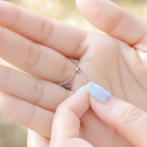 Detail of adjustable 925 sterling silver mesh bead chain ring with sliding clasp