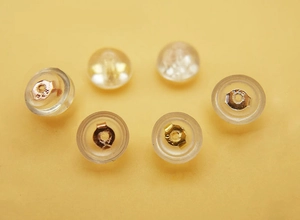 Macro view of S925 sterling silver and silicone earring backs in gold and silver