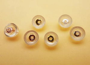 Macro view of 925 sterling silver silicone earring backings in gold and silver finish