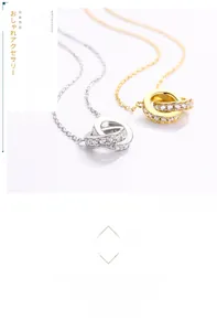 Detail of interlocking silver and rose gold rings with cubic zirconia pavé on O-chain