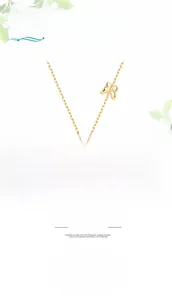 Detail of S925 silver necklace featuring a gold butterfly pendant and a freshwater pearl