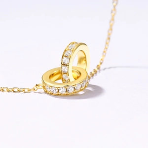 Elegant gold-plated double ring pendant necklace with sparkling micro-pave cubic zirconia