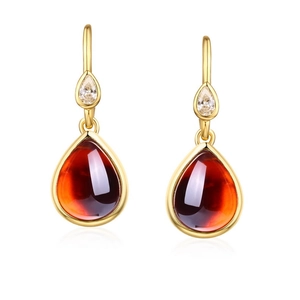 Boucles d'oreilles pendantes dorées avec pierres rouges en poire et détails en zircon