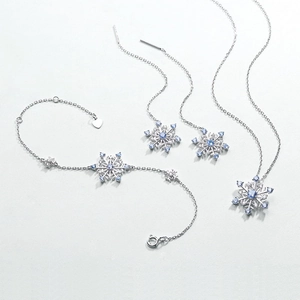 Silver snowflake jewelry set with blue spinels including necklace, bracelet and earrings